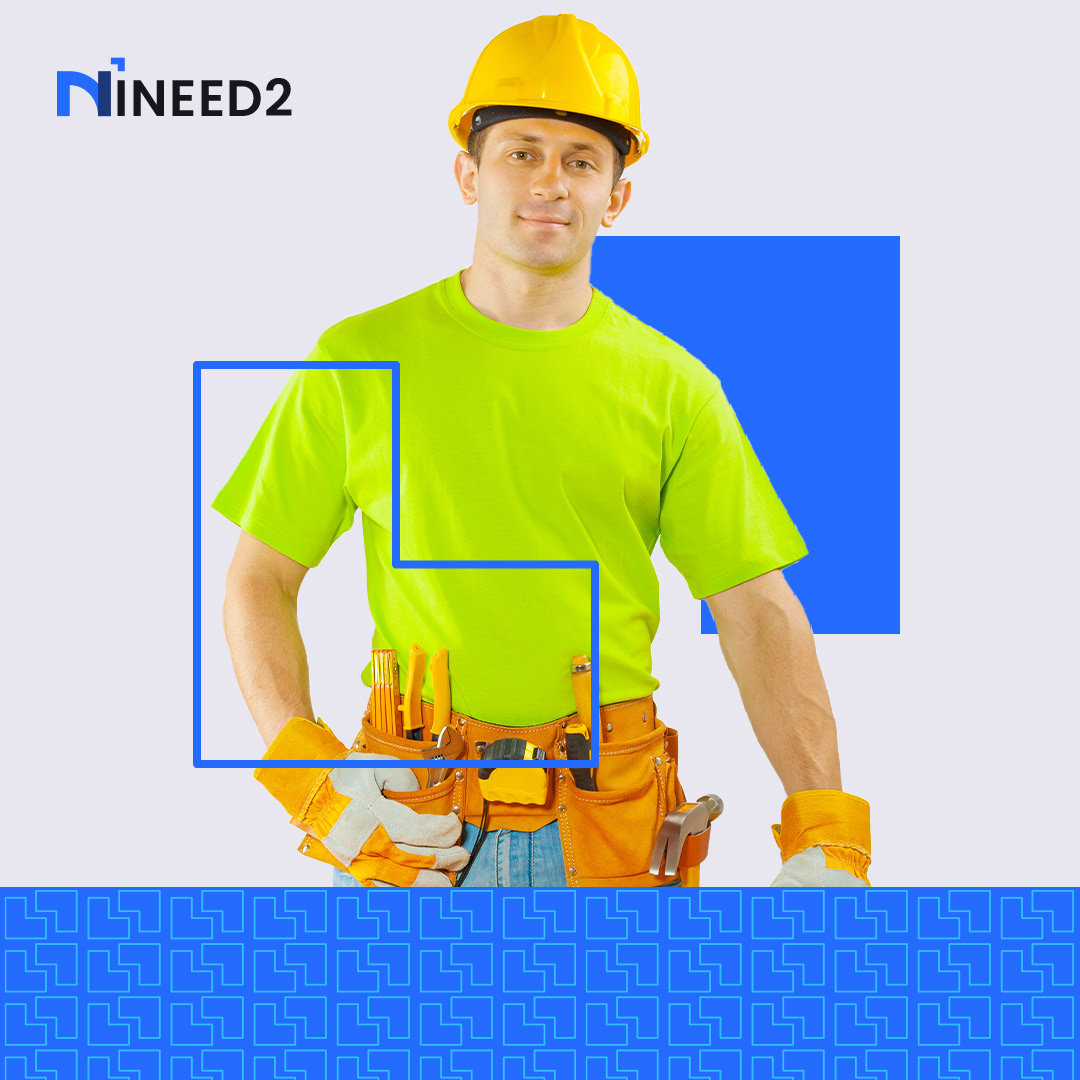An INEED2 handyman tasker in a hard hat with a tool belt.