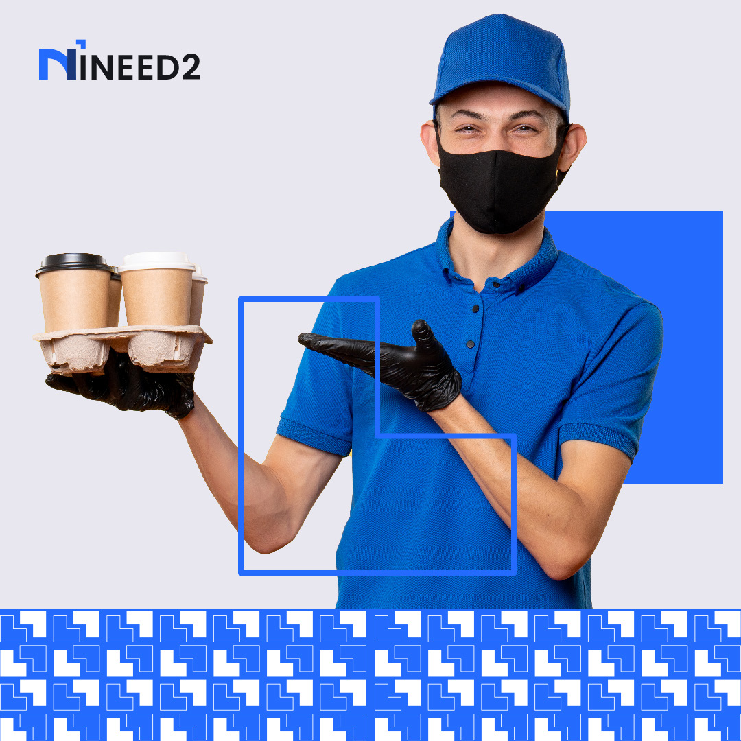 An INEED2 tasker delivering coffee, wearing brand uniform.